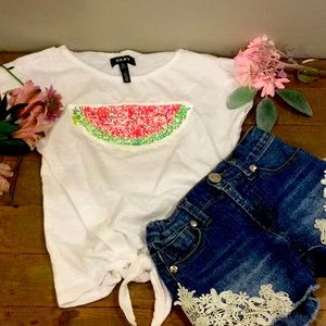 Watermelon white T-shirt with jean shorts.